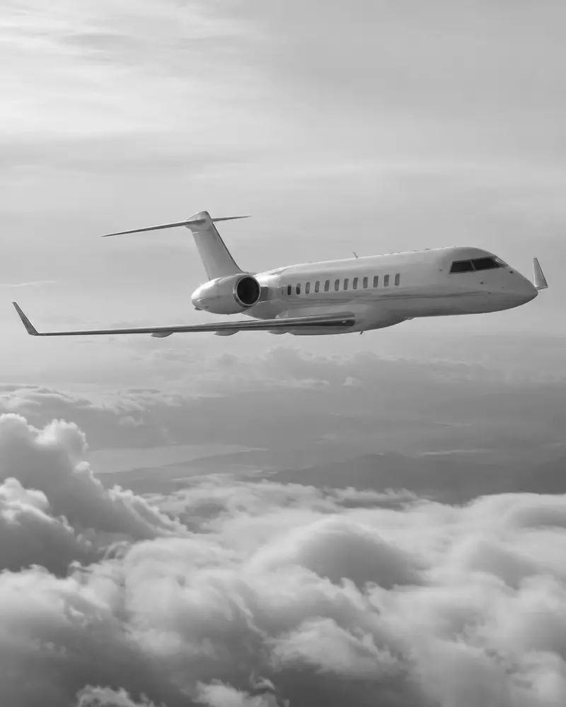Long-range business jet flying above clouds