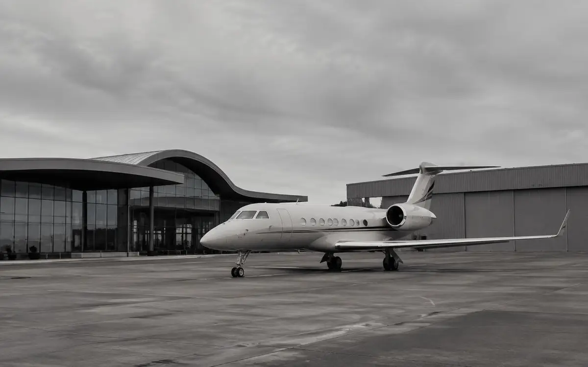 Business jet outside a modern executive aviation terminal